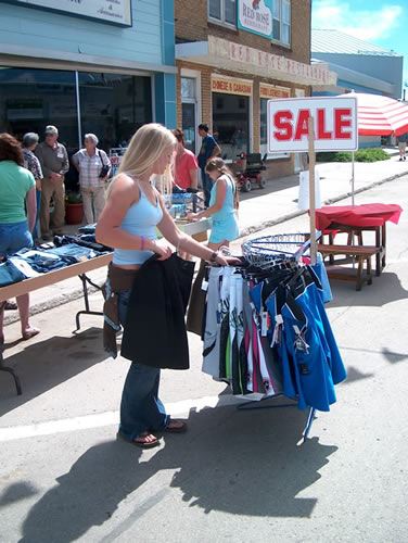 Shopper looking through a sale rack on the sidewalk
